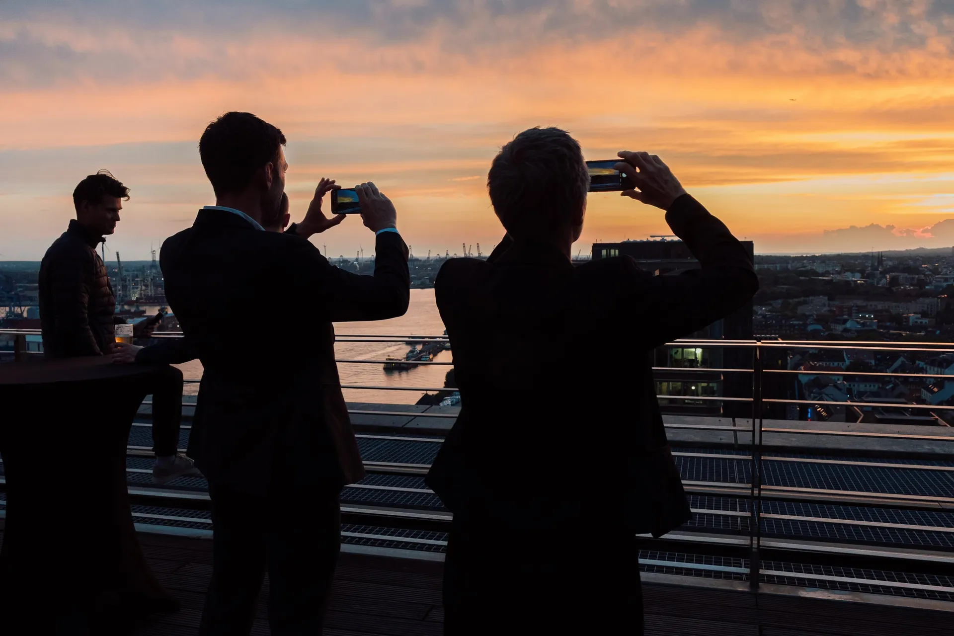 Gäste fotografieren den Sonnenuntergang.