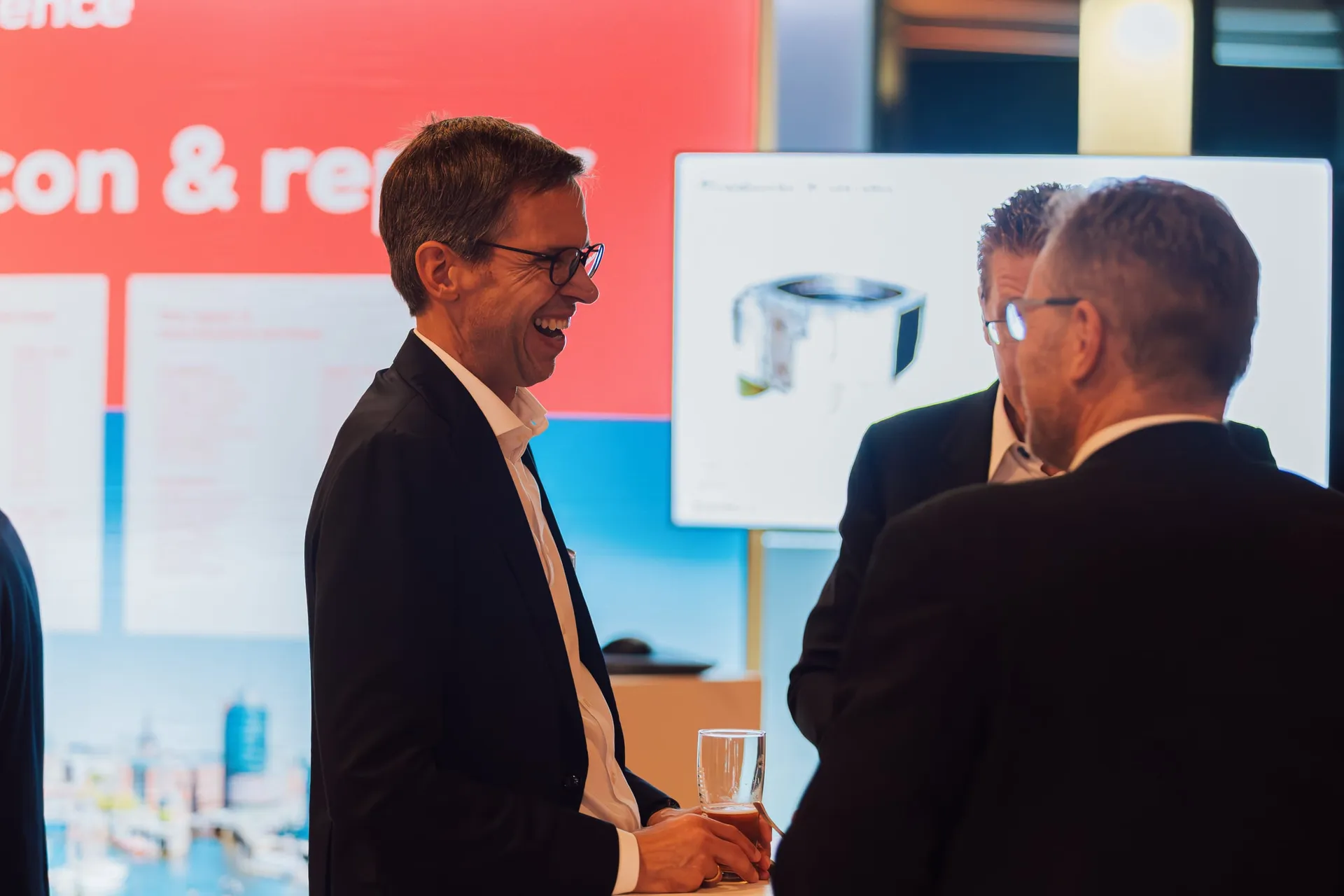 Gespräch vor der Ausstellungswand.