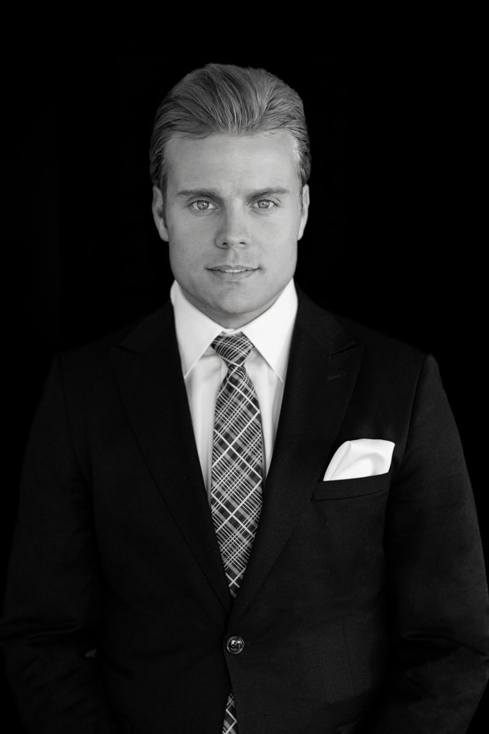 Schwarzweiß-Portrait von Björn Meins vor dunklem Hintergrund.